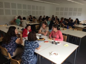 Postgraduate student parents talk to each other around tables
